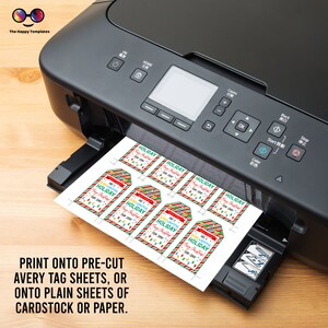 May include: A black and silver printer with a sheet of paper coming out of the tray. The paper has several colorful Christmas gift tags printed on it. The tags have red and green stripes and say "Doh! Lightful Holiday" with a string of lights and a Christmas tree.