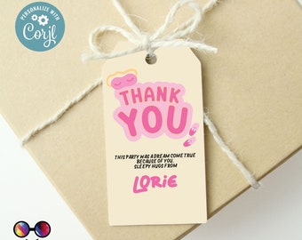 May include: A beige gift tag with the words "THANK YOU" in pink and white, with a sleeping mask graphic. The tag also includes the text "THIS PARTY WAS A DREAM COME TRUE BECAUSE OF YOU. SLEEPY HUGS FROM LORIE."