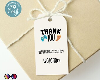 May include: A white thank you tag with a blue and green video game controller and a slice of pizza. The text reads "Thank You", "Mission Sleep Complete! See you on the next one", and "Solomon".