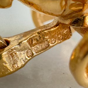 May include: Close-up of a gold chain with a hallmark that reads "AU 585".