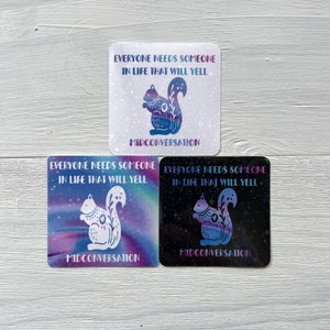 May include: Three square stickers with a holographic finish. Each sticker features a white silhouette of a squirrel with a star-shaped tail. The text on the stickers reads "Everyone needs someone in life that will yell" and "Midconversation".