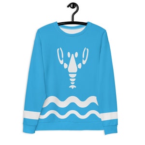 May include: A turquoise sweatshirt featuring a white graphic design. The design includes a face-like shape and a wavy pattern at the bottom. White stripes are on the sleeves.