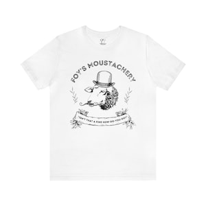 May include: White t-shirt with a black and white illustration of a sheep wearing a top hat and a mustache. The text "FOY'S MOUSTACHERY" is written in a circle around the sheep. The text "ISN'T THAT A FINE HOW-DO-YOU-DO?" is written on a banner below the sheep.