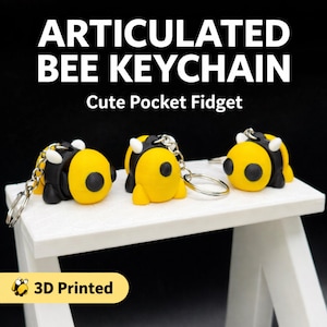 May include: Three articulated bee keychains with yellow and black bodies, white accents, and silver keyrings are displayed on a white surface. The text "ARTICULATED BEE KEYCHAIN" and "Cute Pocket Fidget" are above the bees. The words "3D Printed" are in a yellow box.