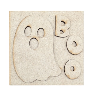 May include: A square light brown wooden plaque featuring a cutout of a ghost shape on the left side and the letters B, O, O cut out on the right side. The ghost has two oval eye cutouts and one circular mouth cutout. The letters O are circular.