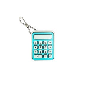 May include: A small, rectangular, bright turquoise calculator keychain featuring a white display area and a grid of white buttons with black numbers and mathematical symbols. A silver-toned metal ball chain is attached to the top corner.