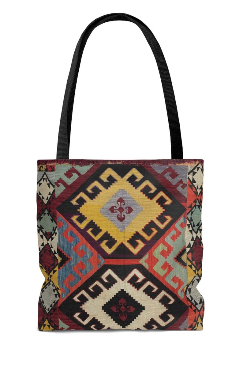 May include: A tote bag with a colorful geometric pattern inspired by traditional Turkish rugs. The pattern features a mix of red, blue, yellow, and white colors.