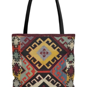 May include: A black tote bag with a colorful geometric pattern inspired by traditional Turkish rugs. The pattern features red, yellow, blue, and green colors.