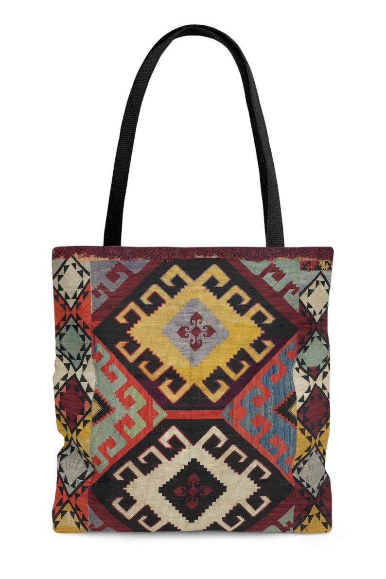 May include: A black tote bag with a colorful geometric pattern inspired by traditional Turkish rugs. The pattern features red, yellow, blue, and green colors.