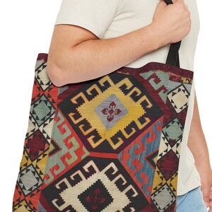 May include: A black tote bag with a colorful geometric pattern. The pattern features squares, diamonds, and triangles in shades of red, blue, yellow, and green.