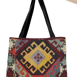 May include: A black tote bag with a colorful geometric pattern. The pattern features red, yellow, blue, and green colors. The bag has black straps.