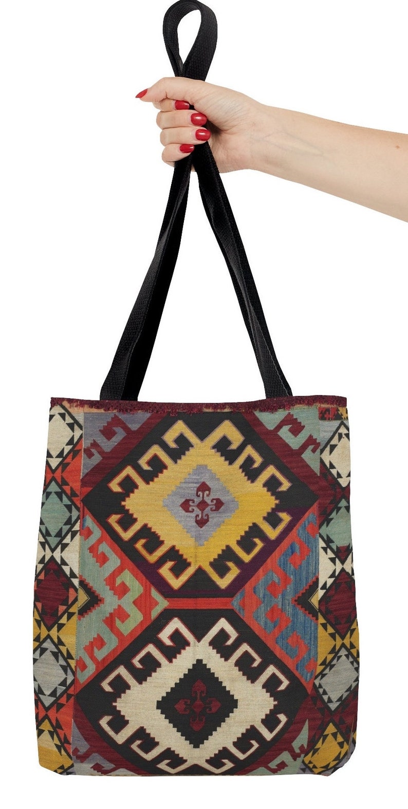 May include: A black tote bag with a colorful geometric pattern. The pattern features red, yellow, blue, and green colors. The bag has black straps.