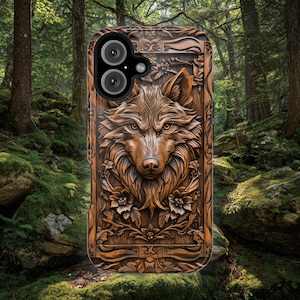 May include: A brown phone case featuring a detailed relief carving of a wolf head surrounded by floral patterns. The design has a wood-like texture with deep grooves and shadows, and the case includes a circular cutout for a dual camera system.