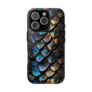 May include: A smartphone case featuring a repeating pattern of iridescent dragon scales in shades of metallic blue, purple, gold, and black. The design covers the entire back of the rectangular device, which includes a triple-lens camera module.