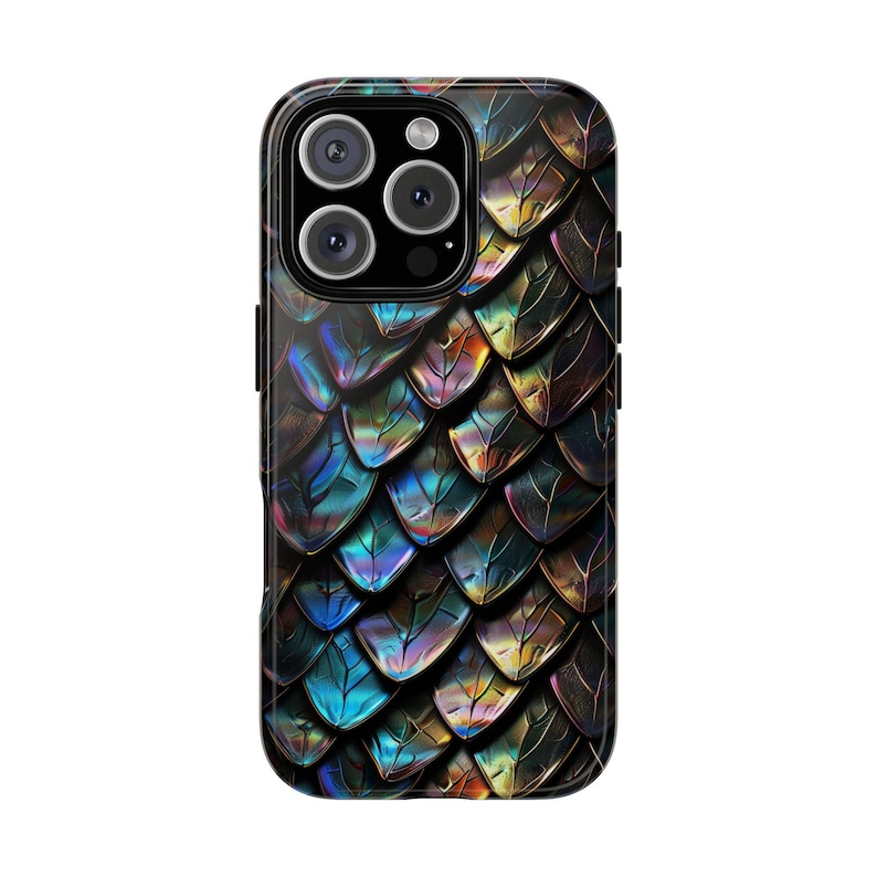 May include: A smartphone case featuring a repeating pattern of iridescent dragon scales in shades of metallic blue, purple, gold, and black. The design covers the entire back of the rectangular device, which includes a triple-lens camera module.