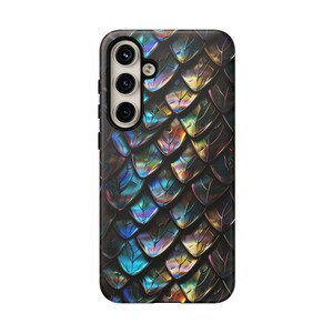 May include: A rectangular smartphone case featuring a repeating pattern of overlapping scales in shades of iridescent blue, purple, gold, and black. The case includes a vertical camera cutout on the upper left side with three circular lens openings.
