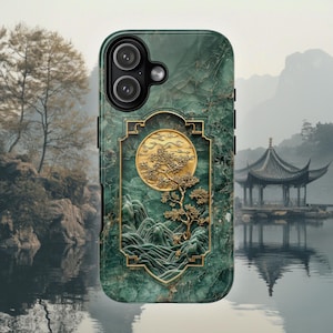 May include: A smartphone case featuring a dark green marble texture background. Centered is a rectangular frame containing a gold-coloured relief of a tree, rolling hills, and a circular sun. The case has a black camera module with two lenses.