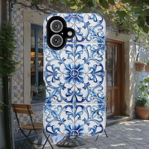 May include: A blue and white phone case with a floral pattern. The case has a raised camera bump and a black border.