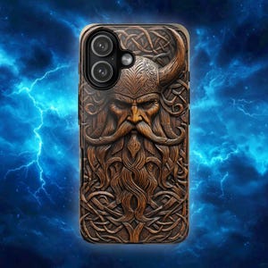 May include: A rectangular phone case featuring a detailed, carved-style brown wood texture depicting a bearded warrior wearing a horned helmet. The design includes intricate Celtic knotwork patterns surrounding the face and a dual-lens camera cutout.