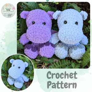 May include: Two crocheted hippopotamus plushies, one purple and one blue, sitting on a bed of green ferns. The text "Crochet Pattern" is displayed below the plushies.