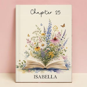 May include: A book cover with a cream background featuring an open book illustration with a vibrant bouquet of wildflowers emerging from the pages. The text Chapter 25 is printed at the top and the name ISABELLA is printed at the bottom in black.