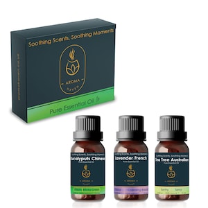 May include: A set of three 10 ml bottles of essential oils. The bottles are labelled "Eucalyptus Chinese", "Lavender French", and "Tea Tree Australian". Each bottle has a black cap and a green label with the words "Soothing Scents, Soothing Moments" and "Aroma Haven".
