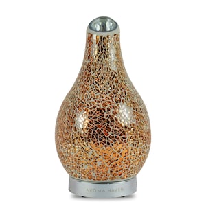 May include: Gold mosaic diffuser with a pearlescent finish and a silver base. The diffuser has a light on the top and says "Aroma Haven" on the base.