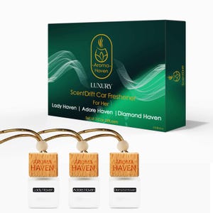 May include: Aroma Haven Luxury ScentDrift car freshener set. The set includes three car diffusers with wooden tops and white glass bottles. The box is dark green with gold accents and the text "Lady Haven | Adore Haven | Diamond Haven".
