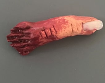 Bloody severed pinky finger. Halloween decoration, creepy gift, gag or horror prop