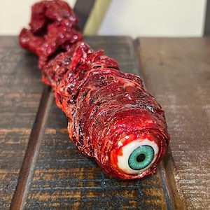 Gory ripped out eyeball, this is a an amazing Halloween decoration, horror prop, or Halloween gift