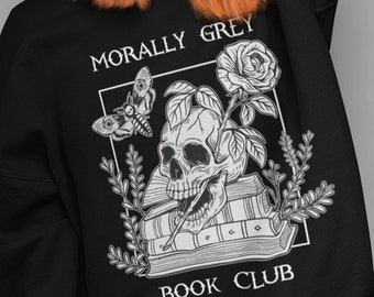May include: Black sweatshirt with a white graphic design of a skull with a rose, a moth, and books. The text "Morally Grey Book Club" is printed on the sweatshirt.