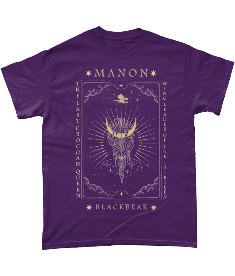 May include: Purple t-shirt with a gold design featuring a crescent moon, stars, and the text "*MANON* THE LAST CROCHAN QUEEN *BLACKBEAK* WING LEADER OF THE THIRTEEN"