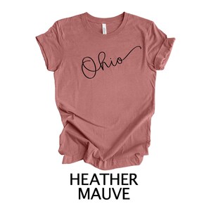 May include: Heather mauve t-shirt with the word "Ohio" written in cursive script.