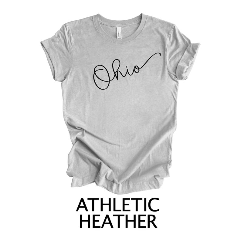 May include: A gray t-shirt with the word "Ohio" written in cursive on the front. The shirt is made of athletic heather fabric.