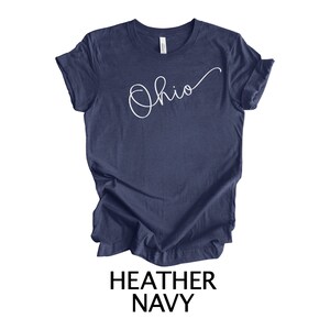 May include: A heather navy blue t-shirt with the word "Ohio" written in white cursive script.