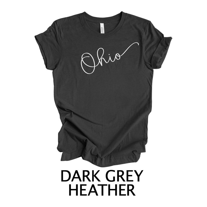 May include: Dark grey heather t-shirt with the word "Ohio" written in white cursive script.