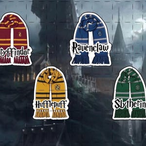 May include: Four sticker designs featuring scarves representing Hogwarts houses: Gryffindor (burgundy and gold), Ravenclaw (blue and silver), Hufflepuff (yellow and black), and Slytherin (green and silver). Each scarf has a house name.