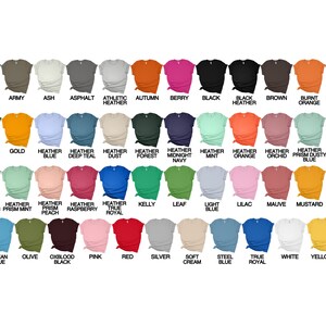 May include: A chart of 36 different coloured t-shirts, each with a short-sleeve crew neck. The colours include aqua, army, ash, asphalt, athletic heather, autumn, berry, black, brown, burnt orange, dark grey heather, forest, gold, heather blue, heather deep teal, heather dust, heather forest, heather midnight navy, heather mint, heather orange, heather orchid, heather prism dusty blue, heather prism ice blue, heather prism lilac, heather prism mint, heather prism peach, heather raspberry, heather true royal, kelly, leaf, light blue, lilac, mauve, mustard, navy, ocean blue, olive, oxblood black, pink, red, silver, soft cream, steel blue, true royal, white, and yellow.