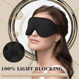 May include: A black sleep mask is worn by a person. The mask is designed to block out light. The text on the image reads "100% LIGHT BLOCKING" and "Creating a dark sleep environment, Fit the nose perfectly".
