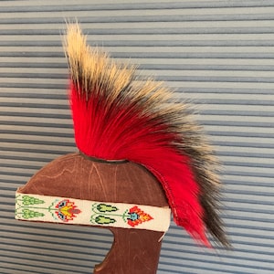 May include: A Native American headdress with a red and black horsehair plume and a beaded headband with floral designs.