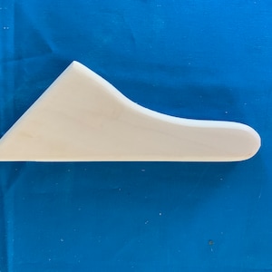 May include: White plastic scraper tool with a curved edge. The tool is designed for spreading and smoothing materials.
