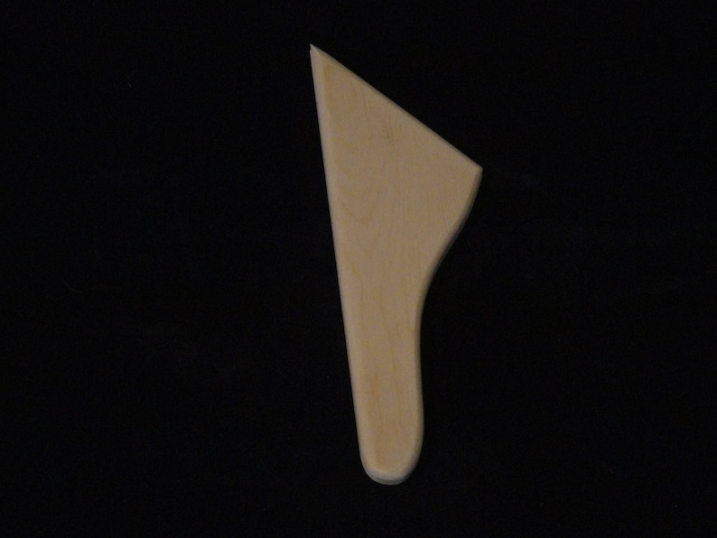 May include: A wooden spatula with a rounded handle and a flat, slightly curved blade.