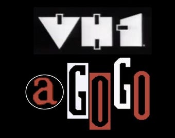 May include: A black and white logo for the music television channel VH1 with the text "a GoGo" in red and white below it.