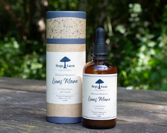 Könnte beinhalten: Eine braune Glasflasche mit Tropfer, die einen Extrakt aus dem medizinischen Pilz Löwenmähne enthält. Die Flasche ist mit "Mogo Farm Organics" beschriftet und enthält einen 1:1-Doppelauszug mit 30% Alkohol. Die Flasche steht auf einer Holzoberfläche.