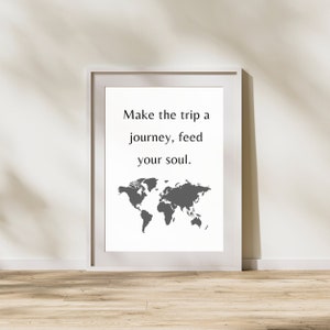 May include: White framed print with a gray world map and the text "Make the trip a journey, feed your soul."