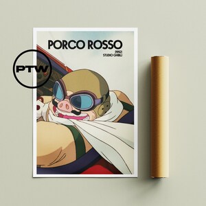 May include: A poster featuring a cartoon pig wearing goggles and a scarf, with the text "PORCO ROSSO 1992 STUDIO GHIBLI" printed below. The poster has a white background and is framed by a white border.