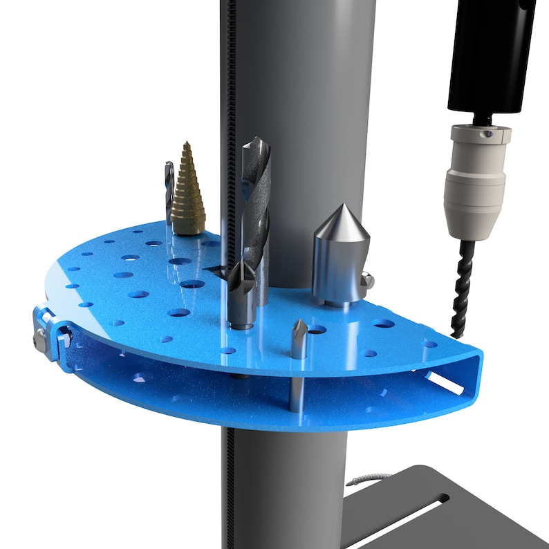 May include: A blue drill bit organizer with various drill bits. The organizer is mounted on a gray drill press. The drill bits are silver and gold in color. The organizer has a semi-circular shape with multiple holes.