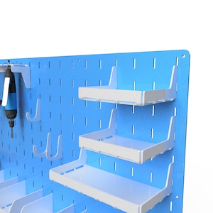 May include: A blue pegboard wall organiser with white shelves and hooks. The shelves are adjustable and can be used to store tools, supplies, or other items. The hooks can be used to hang tools, cords, or other items.