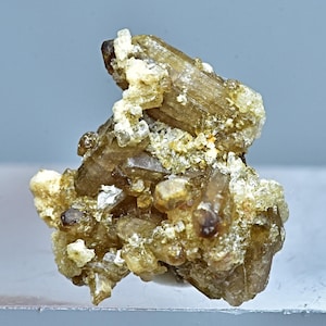 May include: A cluster of brown and clear quartz crystals with a rough, natural texture.