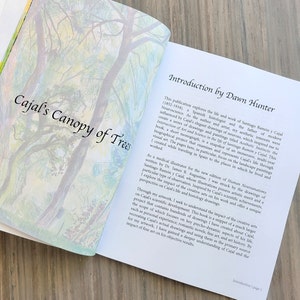 This is an image of the monograph Cajal's Canopy of Trees opened to the title page and introduction by renowned artist and Fulbright Scholar Dawn Hunter.